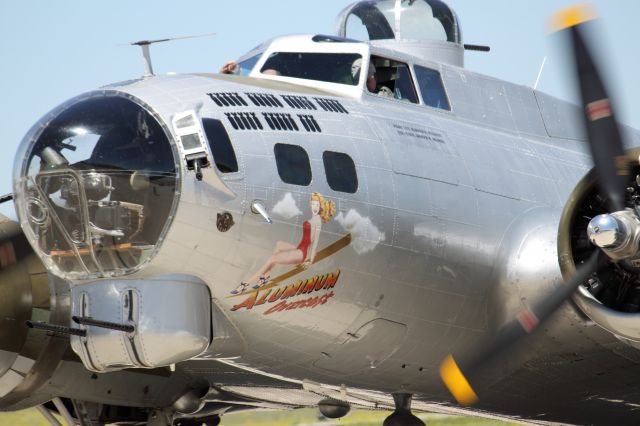 — — - B-17 Aluminum Overcast landing on KFTG ramp in front of terminal