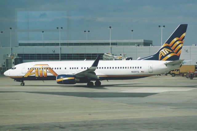 Boeing 737-800 (N320TZ) - Scanned from print. Shot through terminal glass.