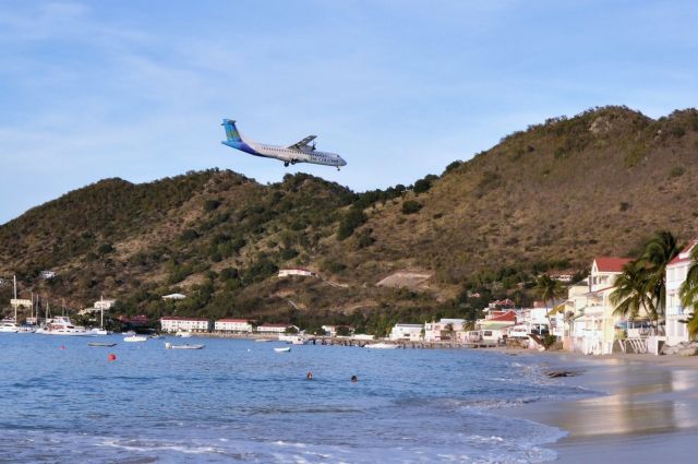 ATR ATR-72 — - Standing on the beach of Grand Case Village, St. Martin.