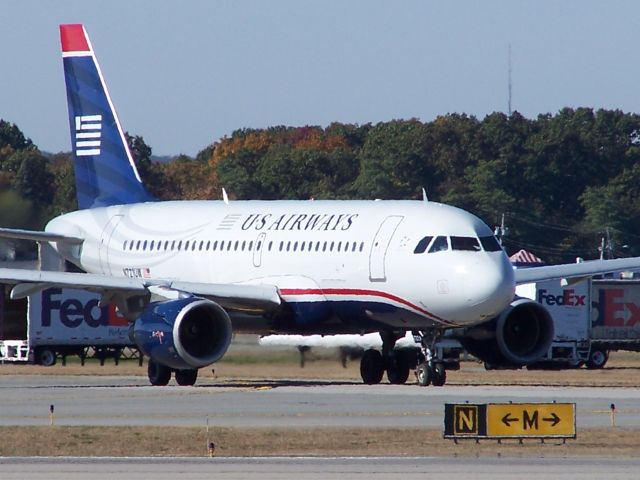 Airbus A319 (N721UW) - N721UW waits for its turn on the runway at Providence.