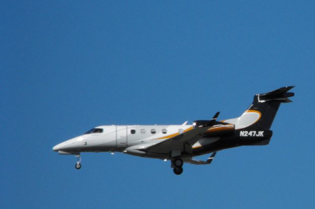 Embraer Phenom 300 (N247JK) - Moment or two from landing is this Embraer Phenom 300 in the Autumn of 2015.