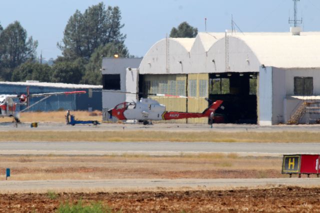 Beechcraft King Air 90 (N107Z) - KRDD - USFS 1983 Bell 209 (AH-IS Cobra) Firewatch Cobra C/N 22342 being pushed back into the hangar on a very warm heat-hazed day at Redding - I have not been able to snag a good snap of this Cobra yet!