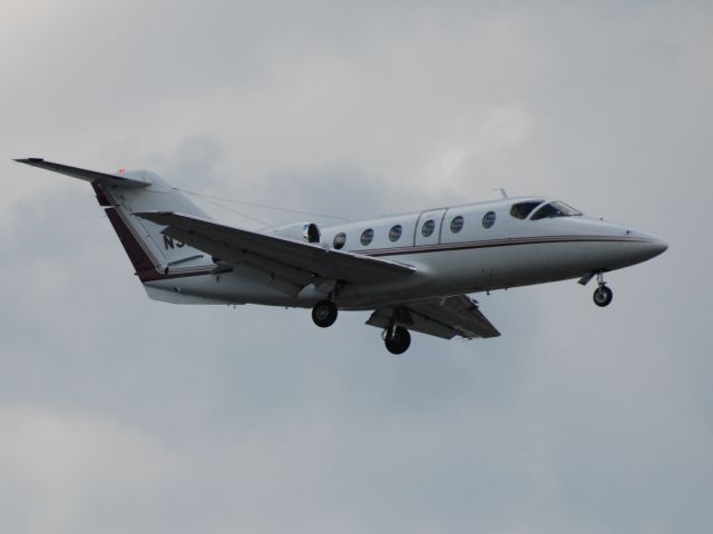 Mitsubishi MU-300 Diamond (N32HP) - Sitting at a red light, in the rain, took the photo out the side window of the car!! N32HP landing at Torontos Pearson Airport May 4/10.