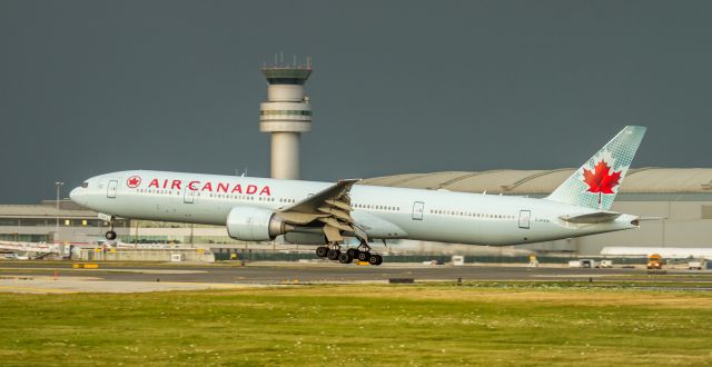 BOEING 777-300 (C-FIVQ) - About to touch down on 24R with the storm imminent!