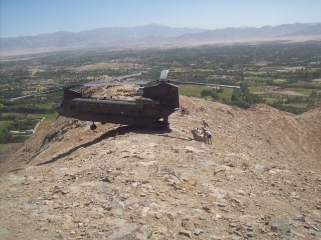 — — - CH-47 delivering supplies to a mountaintop in Afghanistan.