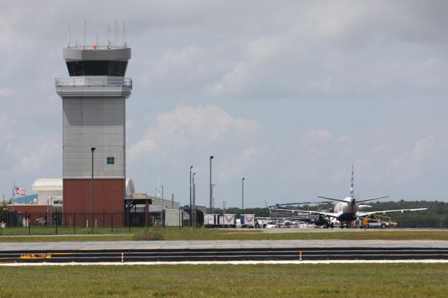 Embraer ERJ-190 (N273JB) - Jet Blue E190 at HYA, parked next to the new Tower to the left, and new terminal in back.