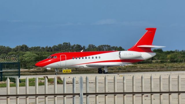 Dassault Falcon 2000 (ZS-PKR) - After landing from King Shaka International FALE on Rwy 26, this Falcon 2000 is taxiing on Alpha to the Private Bays at Chief Dawid Stuurman International at Gqeberha International (formally Port Elizabeth) FAPE. This photo used with permission from my brother, who snapped this with his mobile phone.