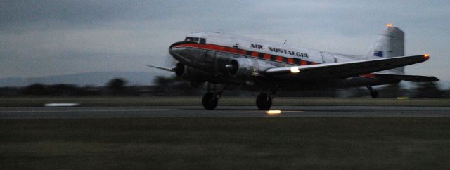 Douglas DC-3 (VH-TMQ) - landing at Essendon at dusk, June 2018