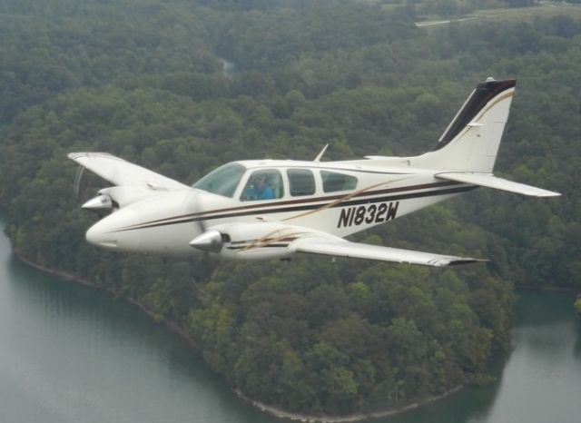 Beechcraft 55 Baron (N1832W) - Flying over Tim's Ford Lake...chase plane is a Bonanza piloted by Ted Nickson, photo by Sandra Nickson. David Moore piloting the Baron with Todd Meucci and his Dad, Bernie.