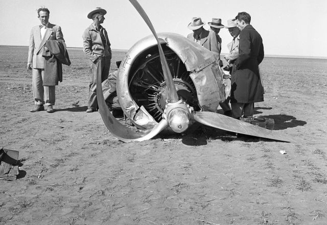 N65143 — - Surveying No 1 engine (P&W R-2000) that fell off DC4 as a result of in flight fire. Hugoton, Kansas, Mar 26, 1952. Photographer unk,from discarded Braniff accident files