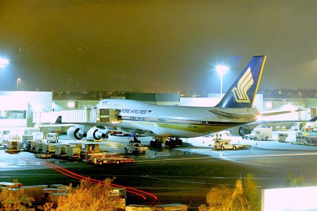 Boeing 747-400 (9V-SMB) - KLAX - 1990 view of the TBT and Megatop 747-4 of Singapore Airlines, This jet was probably 1 yr old when I took this - night photos not my best Class...this jet flew with Ansett Australia, Fiji Air and Air Pacific and scrapped in 2013 - I did not know SIA recycles old Reg numbers...