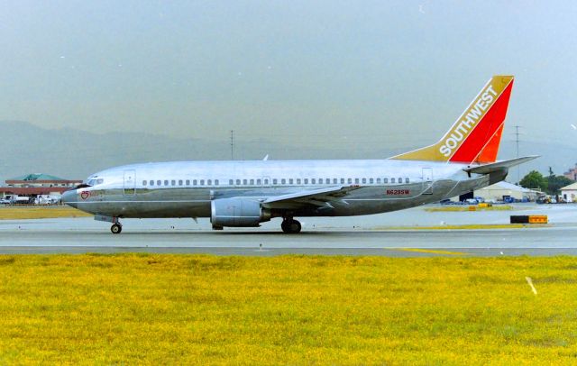 BOEING 737-300 (N629SW) - KSJC - at 30L at San Jose, dont remember which year I took this but possible late 1990s from the old utility box location. Anniversary Silver ,some paint scheme.