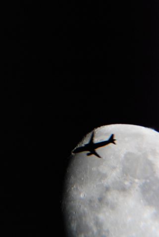 — — - AIRLINER PASSES MOON