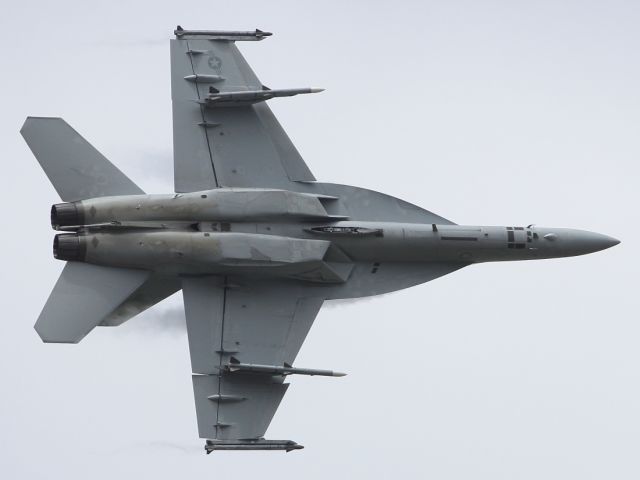 — — - The FA-18 Super Hornet shows off it's underbelly while performing a tight turn at RIAT 2012.