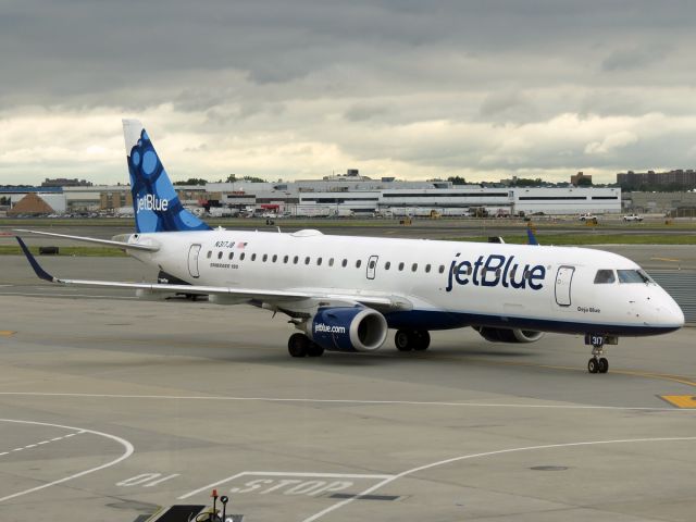 Embraer ERJ-190 (N317JB) - JetBlue Airways and American Airlines are the only major US airlines who use E-Jets within their mainline operations rather than solely through regional affiliates. Seen pulling into the gate in August 2014.