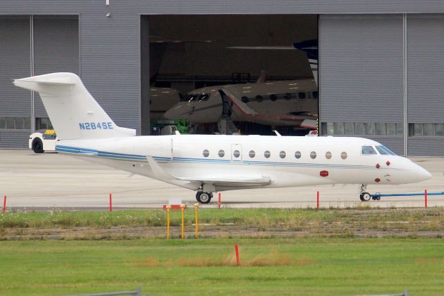 IAI Gulfstream G280 (N284SE) - Under tow to the East Apron on 3-Aug-21.