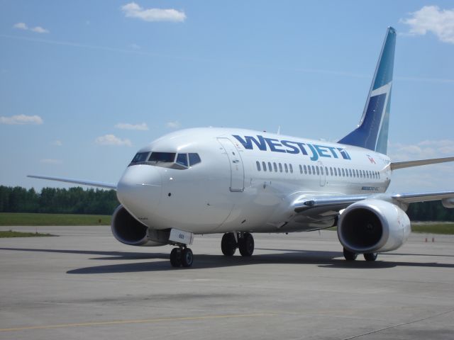 BOEING 737-600 — - West Jet Boeing 737-600 taxiing in for ground loading at the Fort McMurray Airport on a hot summer afternoon.