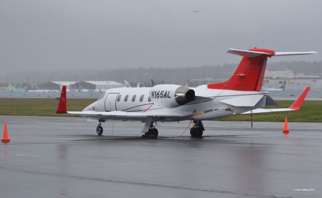 Learjet 31 (N165AL) - N165AL of Aero Air Llc. Seen from the rear of the plane by the FBOs at KBFI. This aircraft has Airlift Northwest titles on the nose. Also notice the 737s in the background. These 737s are destined for Continental, Star Alliance, Ryanair, Royal Air Maroc, Skymark, Xiamen Airlines, and two unknown airlines. Please look for more photos at Opshots.net