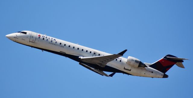 Canadair Regional Jet CRJ-700 (N374CA) - This GoJet bird needs a bath! Off to DCA, from the top of the RDU parking deck, 4/12/18.