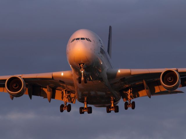 Airbus A380-800 — - Sunset lights up the A380-800 as it approaches runway 027R.