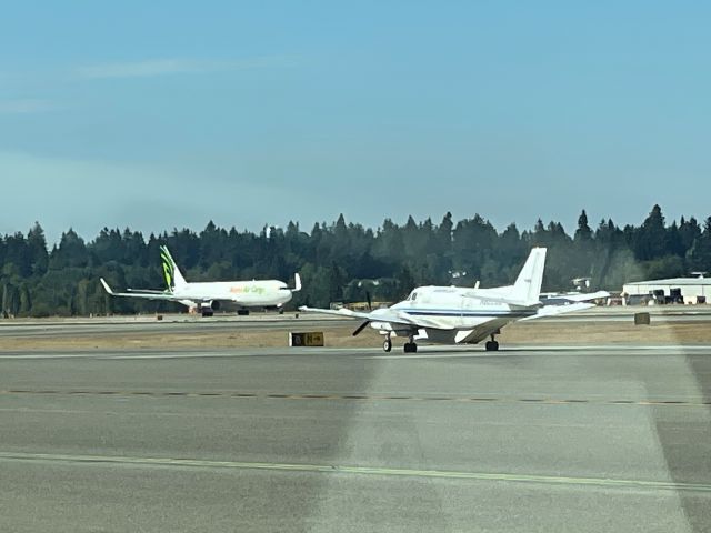 Beechcraft Airliner (N8226Z) - On the service road to fuel a Horizon Q400..when I saw the BE99 earlier this morning, now taxiing southbound for a northbound departure runway 34R. (-: