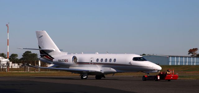 Cessna Citation Latitude (N623QS) - Receiving a tug to pre-flight parking is this 2020 Cessna Citation Latitude 680A in the Autumn of 2021.