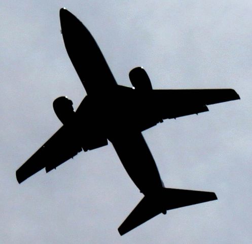 — — - A US Airways jet is silhouetted, as it passes over Oakhill Cemetery  In San Jose, California, On Final to  San Jose International Airport (SJC / KSJC)