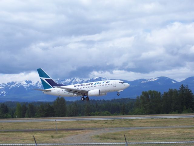 C-GWCO — - West Jet Commercial jet landing at CFB Comox, British Columbia    CFB Comox Military Base shares itts runways and fueling facilities with Comox Valley Airport passenger & commercial service