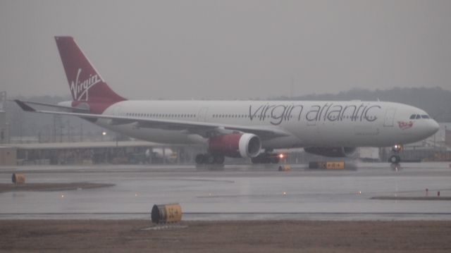 Airbus A330-300 (G-VINE) - Rainy and foggy at KATL.  Taxing after arrival on 10/28.