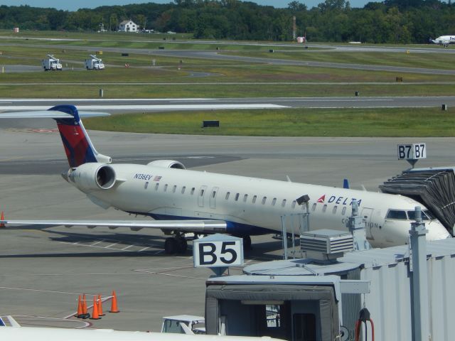 Canadair Regional Jet CRJ-900 (N136EV) - A Delta CRJ900 at Albany boards for the 1:00 flight to Atlanta.