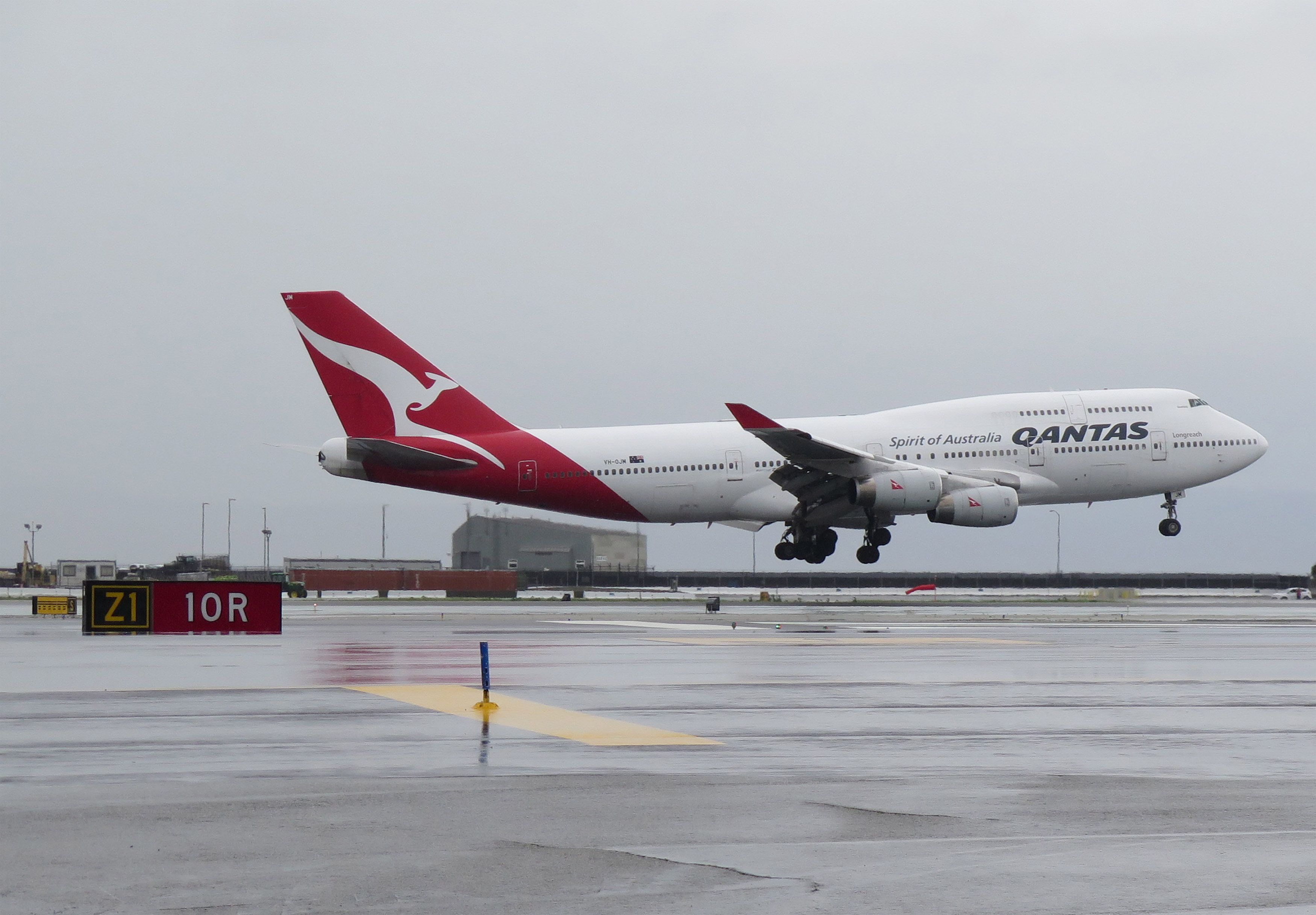 Boeing 747-400 (VH-OJM) - QF flight landing on runway 10L during this rare landing event in SFO due to stormy weather condition.