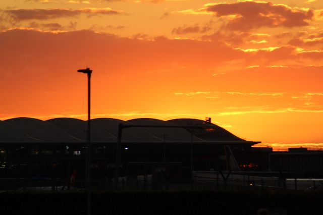 — — - London Heathrow Airport's T2 in the Sunset.