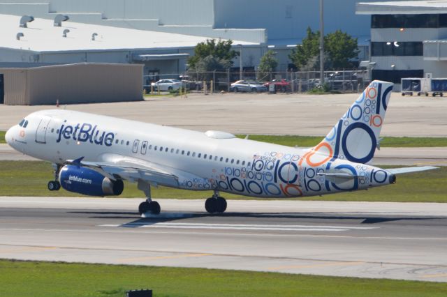 Airbus A320 (N569JB) - Left landing gear making initial contact with RWY 28R