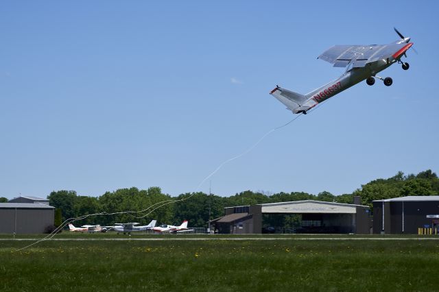 Cessna Commuter (N66637) - This Banner Tow Pilot rapidly pulls up after snagging his banner with the trailing hook.