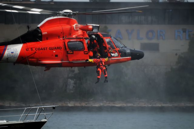 N6605 — - Rescue swimmer exiting helicopter during a rescue drill with Naval Academy sloop.  4-2-2016