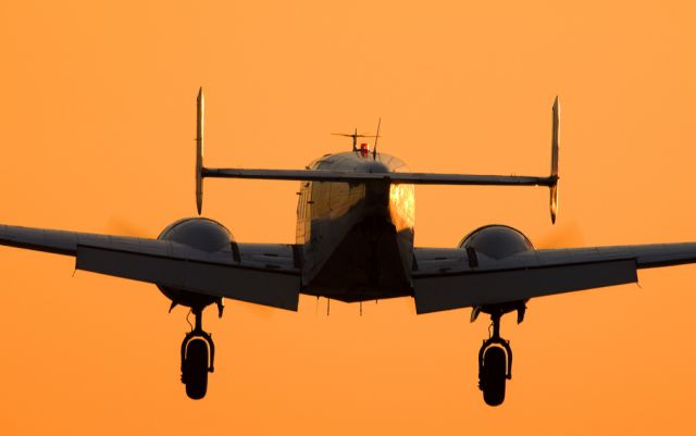 — — - Beech 18 at runway 25L.