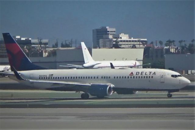 Boeing 737-800 (N373DA) - A normal Delta Boeing 737 taxis past us as we approach our gate.