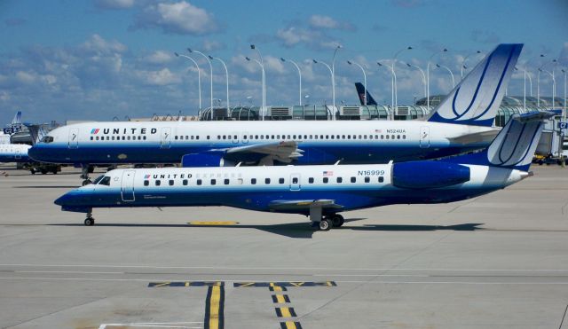 Embraer ERJ-145 (N16999) - United Express (ExpressJet) ERJ-145LR in front of UA 757-222 N524UA at ORD on June 29, 2010.