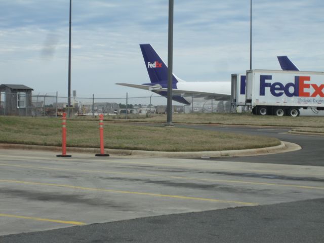 Airbus A310 (N716FD) - Two FedEx planes (Airbus A300B4-622 N716FD in front, you can only see the tail of Boeing MD-10-10F N385FE in the back) are both relaxed at R.D.U. on New Years Eve of 2012. This plane came in as FDX1738 from IND and will take off as FDX1638 to IND.