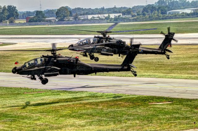 — — - Two AH-64 Apache helicopters fly slowly in preparation for a demonstration at the 2008 Dayton Airshow.