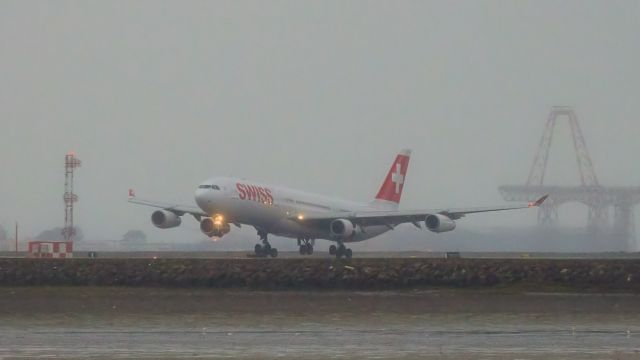 Airbus A340-300 (HB-JMA) - Late rainy afternoon arrival from Zurich on 19R instead of the of one of the 28s