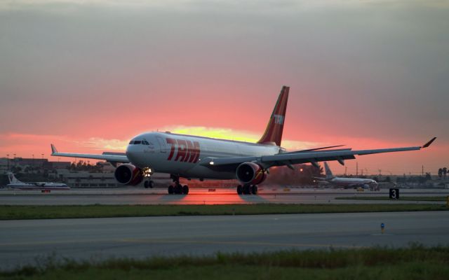 Airbus A330-200 (PT-MVA) - TAM A330-200 main down with the setting sun behind it on R12.