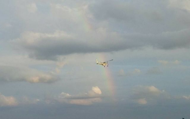 HELIO U-10 Super Courier (N461FM) - Helio Courier flying through rainbow at M17- Bolivar, MO