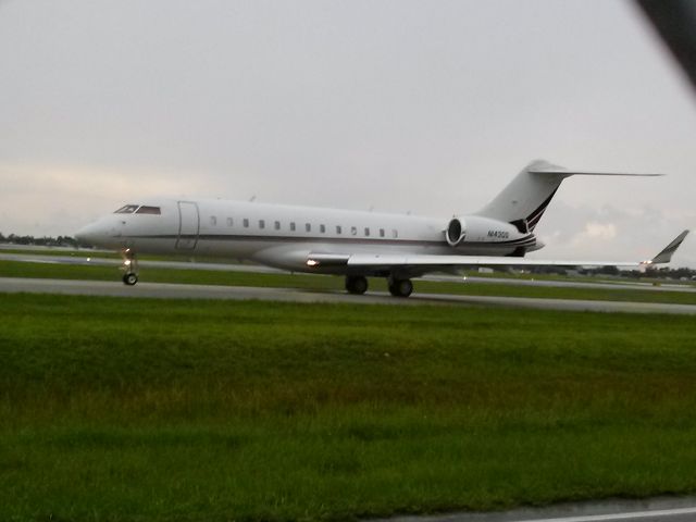 Bombardier Global Express (N143QS) - out side of fence area and pictured it taxi to take off 