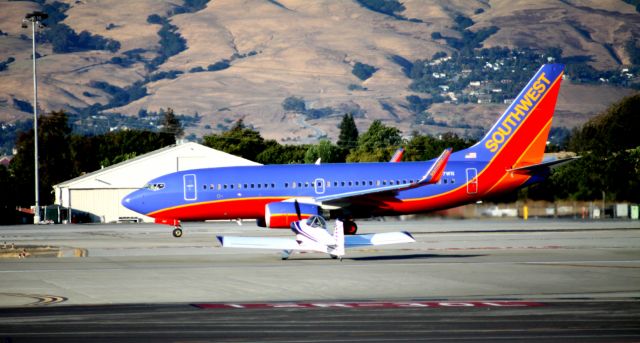 Boeing 737-700 (N447WN) - "When I Grow Up" .. SW "rolling" 30L for take off, while N26ML in fore ground, (Lewis-Rundle-RV-4-180-Experimental) awaits its turn for take off