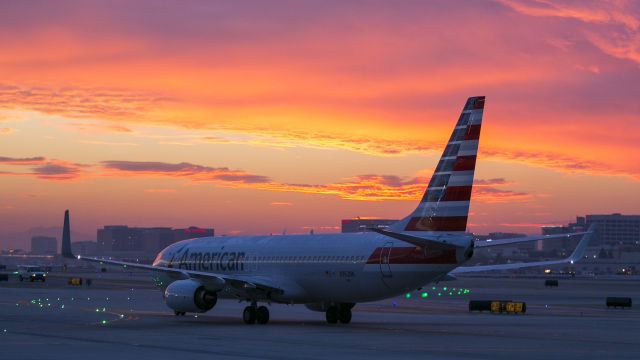 Boeing 737-700 (N962NN) - This Boeing 737 is being taxied at dawn to its gate by Aircraft Maintenance Technicians after a night of maintenance at the American Airlines Hangar LAX. This is a classic red sky from the old "Red sky in morning, sailors take warning" proverb. The weather quickly closed in and it has been raining steadily here in Los Angeles all day and into the night. 