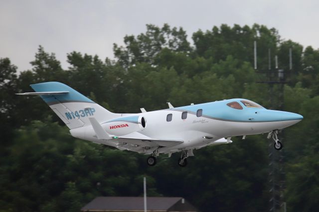 Honda HondaJet (N143RP) - HA-420 HondaJet Elite, seen at KTOL on a rainy Sunday, 2 Aug 2020. 