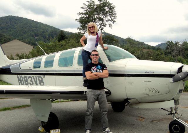 Beechcraft Bonanza (36) (N183VB) - Alexandria Ulyicsni standing on wing with Boone, NC mountains in background.