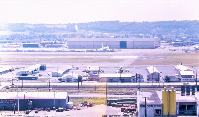 BOEING 747-100 (N7470) - KBFI - This is where it all started for me...though several year earlier, This photo taken within 200yd or slightly to the left in the view - was where our house used to be...torn down for Interstate 5 construction pre June 1964(below out of view). I was old enough to watch the development of the Boeing 727 from this vantage point on our back porch looking the same direction. We could see 95% of the runway to the left, then blocked by trees. From the late 1950s till we move to California in June 1964 - I saw just about every type of jet built in the USA and used by the Military services. We did not see any super secret jets, though we did see 50s era Globe masters arriving at night and unloading tarped items or leaving after loading tarped items. All century Series jets, most airliners, B-17 and some B-29s, 1 B-58 Hustler...I'll never forget that take off...707s. KC-135s, B-47s, B-52s all propliners big and small and multiple aircraft emergencies with engines on fire ( usually Stratoliners, DC-6 or Convair 240s) diverted from SEA-TAC just over the hill top left of the photo with 30 Fire engines from all over south Seattle responding to every gate at BFI. The Boeing 727 was magnificent to watch as flight testing daily occurred here daily right up until we moved. I missed the 737 747 757/767 not being here but I'll never forget the early days at BFI, This photo taken apprx 1976 on my many trips back to Seattle to visit relatives,,,never complete without cruising BFI. and yes, I sure wish I had a camera back then, but that was a luxury item for us.