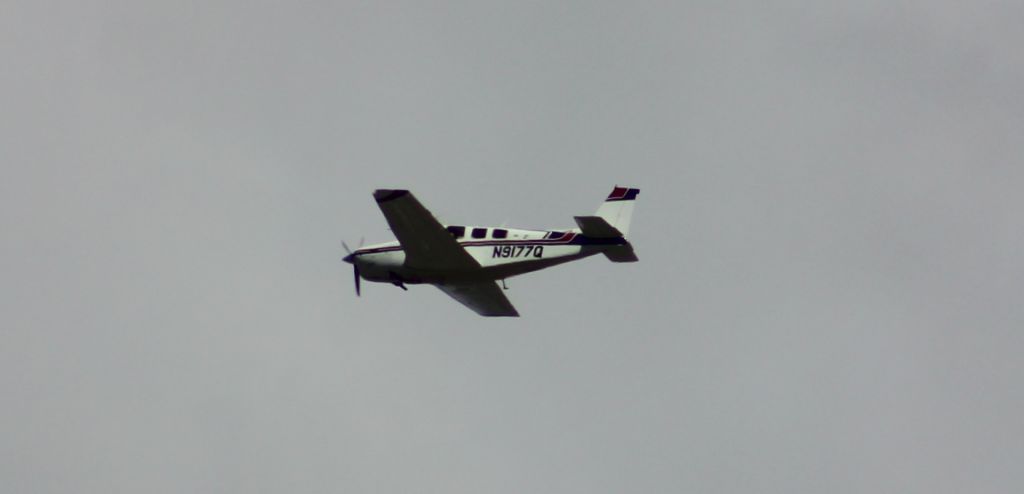 Beechcraft Bonanza (36) (N9177Q) - N9177Q departing MYF 21MAR2020. Telephoto taken approx 1217 while sitting on my balcony in the community of Clairemont, San Diego CA on this beautiful, puffy white cloud laced first day of Spring during one of my favorite pastimes: drinking a cup of coffee watching the planes go by.